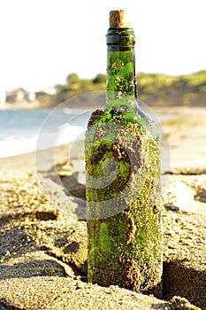 Message in a glass bottle in a beach