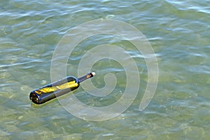 Message in glass bottle in the sea