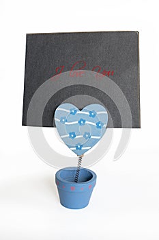 Message holder with a greeting card isolated on white. I love you, Valentineâ€™s day.