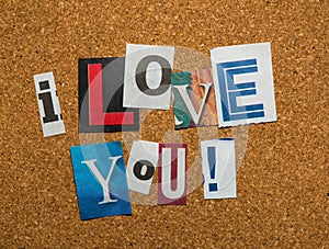 The message -I Love You- with cutout letters on corkboard