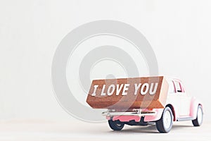 Message I love you on wooden blocks and car with copy space, vintage tone..