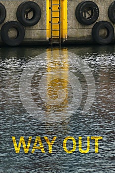 Message - way out - in water canal with a ladder leading upward