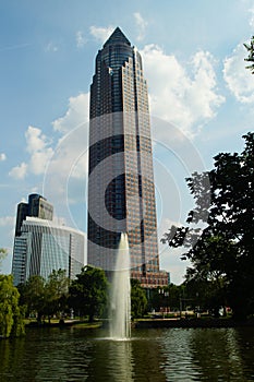 The Messeturm rises behind a fountain. photo