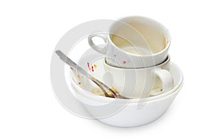 Messthetics aesthetic concept. A photo of dirty empty ceramic cups, bowls, two spoons and a plate isolated on white background. Di