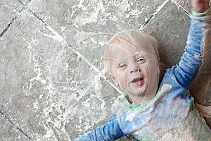 Messy Baby Covered in Baking Flour