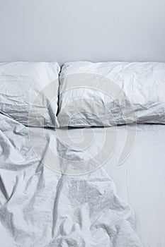 Messy bed with gray bedclothes photo