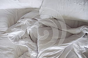 Messy Bed. White Pillow and Blanket in Bedroom, Relaxation and C