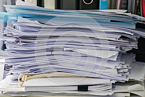 Messy business documents piles on office desk