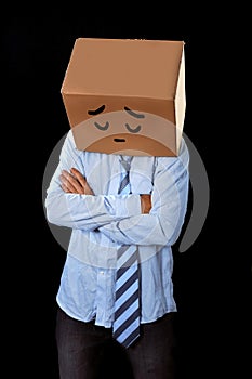 Messy business man with carboard box on head sad expression draw