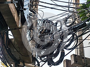 Messy cable lines on electricity power pole