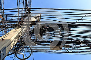 Messy cables attached to electrics pole