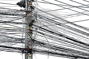 Messy chaos of cables with wires on electric pole on white background