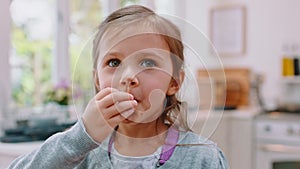 Messy, chocolate and face of girl in kitchen for food, candy and breakfast spread. Happiness, dessert and comic with