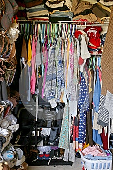 Messy Closet Filled with Woman's CLothes photo