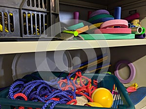 A messy disorganised school games storage cupboard photo