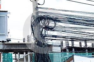Messy electrical cables in thailand - many lines of cables chaotic set of interwoven, optical fiber technology open air outdoors