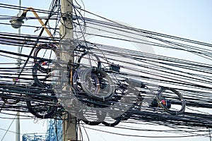 Messy electrical cables and wires on electric pole