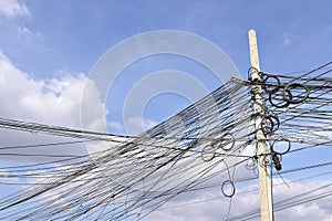 Messy electrical cables wiring on concrete electric pole