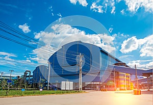 Factory warehouse building in industrial estate with messy electrical wire cables.