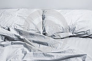 Messy gray bed linen