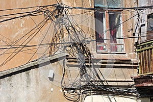 Messy heap of communication cables, wires on the wall