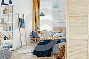 Messy kid`s bedroom with toys and wooden furniture real photo photo
