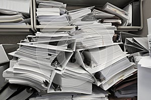 Messy Office Pile of Binders with Papers Filing Disorganized Mess