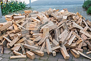 Messy pile of firewood on a drive