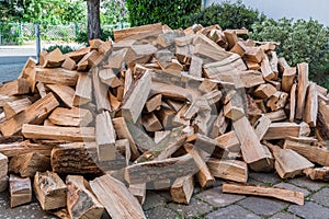 Messy pile of firewood on a drive