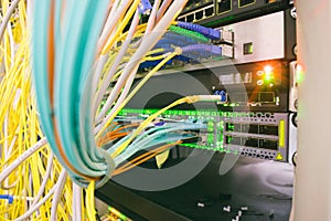 Messy plex of wires in the server rack of the data center. High-speed Internet cables are connected to 10G interfaces of the