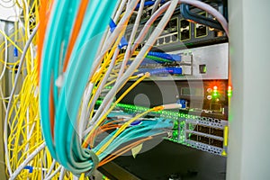 Messy plex of wires in the server rack of the data center. High-speed Internet cables are connected to 10G interfaces of the