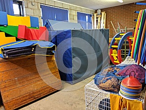 A messy sports hall equipment storage area