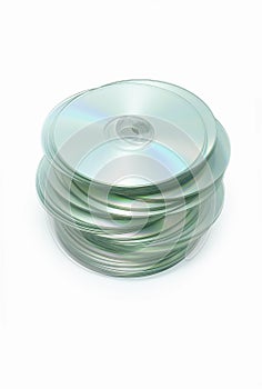 Messy stack of CD disks on white