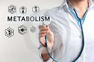Metabolism concept. Doctor with stethoscope on light background, closeup