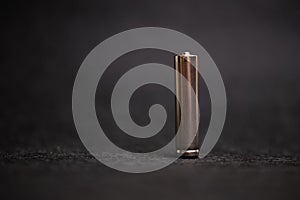 metal AAA battery on a black background