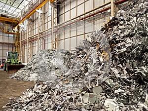 Metal and Aluminium scrap pile and dozer in recycle factory