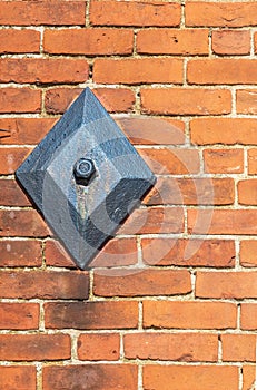 Metal anchor plate on a brick wall