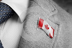 Metal badge with the flag of Canada on a suit lapel