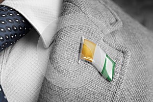 Metal badge with the flag of Cote dIvoire on a suit lapel