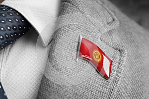 Metal badge with the flag of Kirghizia on a suit lapel