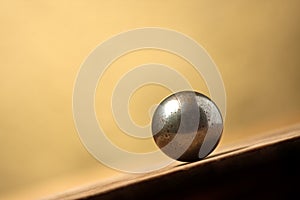 Metal ball on sloping surface