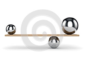 Metal balls balanced on plank