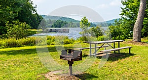 A metal barbeque grill and a picnic table at Chapman State Park in Clarendon, Pennsylvania, USA