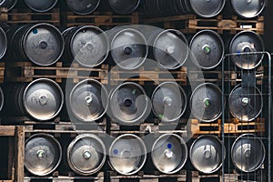 Metal barrel. Keg with beer. A large number. Stock. Logistics and alcohol concept. Wooden pallets