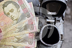 Metal barrel and Ukrainian money, the concept of the cost of gasoline, diesel, gas. Refilling the car. Banknotes 100 hryvnia