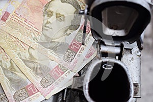 Metal barrel and Ukrainian money, the concept of the cost of gasoline, diesel, gas. Refilling the car. Banknotes 100 hryvnia