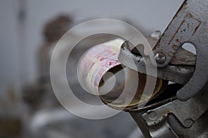 Metal barrel and Ukrainian money, the concept of the cost of gasoline, diesel, gas. Refilling the car. Roll of banknotes 100