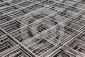 Metal bars background in diagonal lines close-up, industrial mesh of steel wire texture, building material