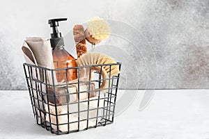 Metal basket with natural cleaning products and tools. Bamboo accessories and natural products for cleaning the kitchen