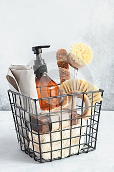 Metal basket with natural cleaning products and tools. Bamboo accessories and natural products for cleaning the kitchen